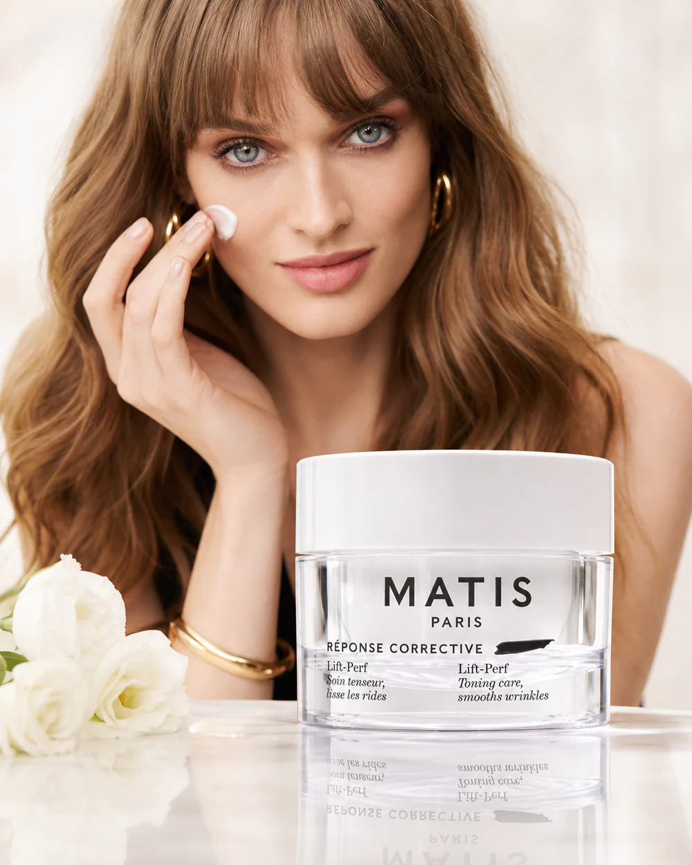 Woman applying LIFT-PERF lifting cream by MATIS Paris for firmer, smoother and more youthful-looking skin.