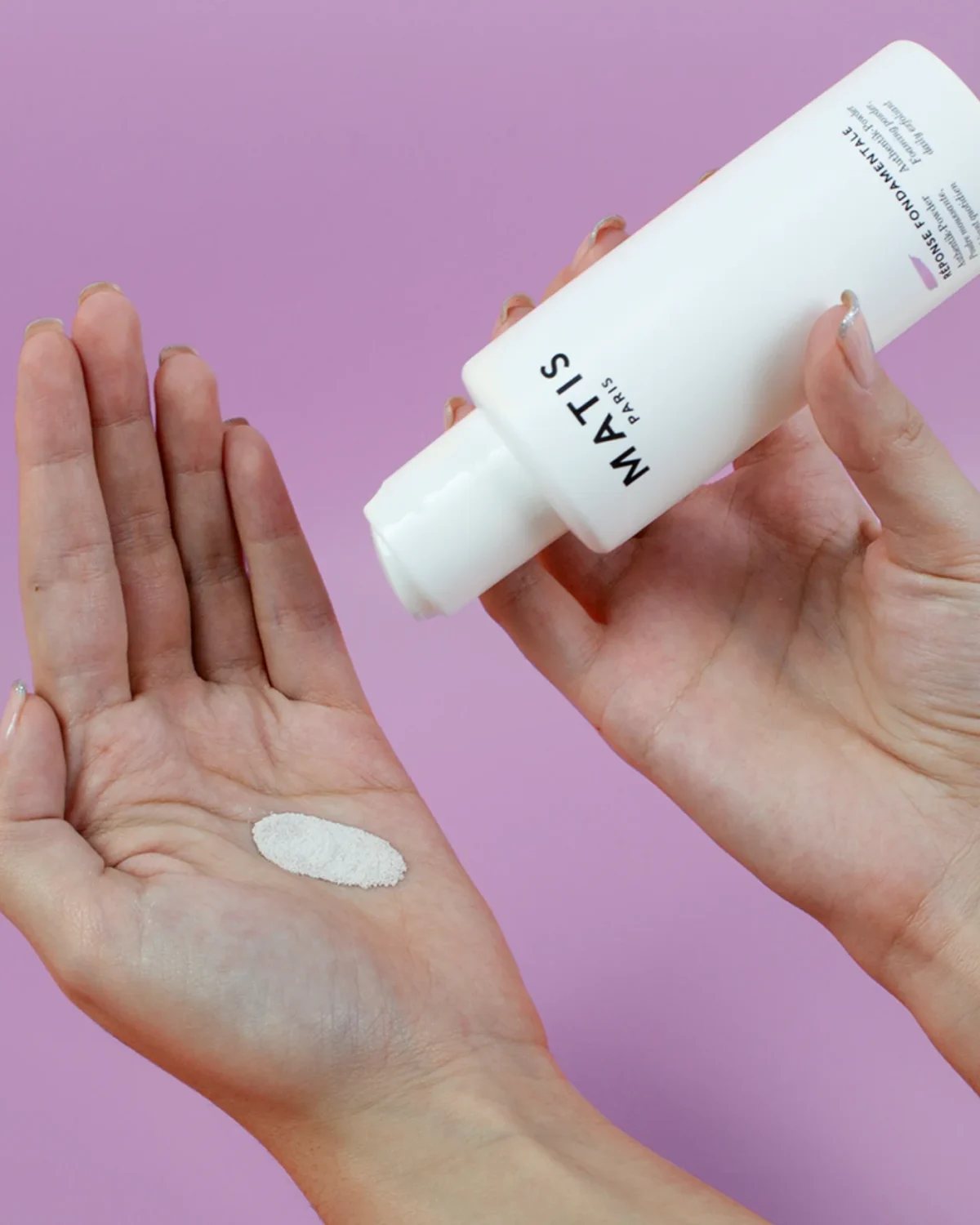 Woman cleansing her face with AUTHENTIK-POWDER Daily Exfoliating Cleansing Powder by MATIS Paris for smoother, brighter skin.